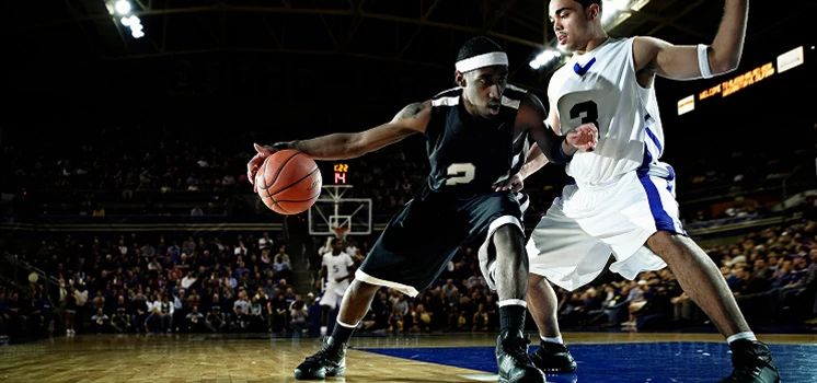 Pro basketball players on basketball court.