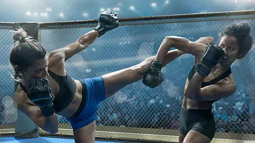 Two female athletes fighting MMA